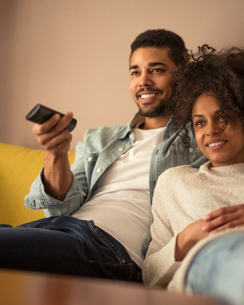 Couple on a sofa watching television in the evening