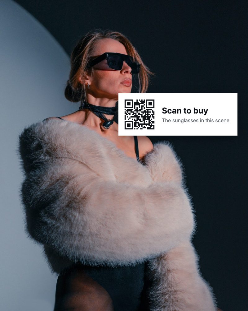 Fashion programme still with a Scan to buy code beside the presenter